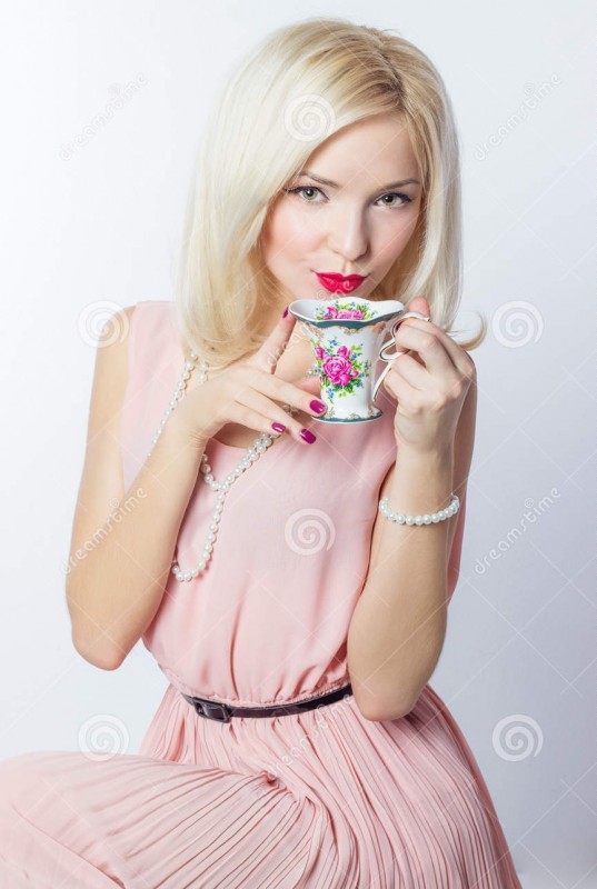 beautiful-smiling-happy-sexy-elegant-girl-red-lipstick-pink-dress-retro-style-drinks-tea-coffee-small-mugs-47153760