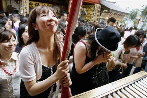 Women pray for good relationships or good luck in love during "Tanabata", or the Star festival, at Jishu shrine in Kyoto, western Japan July 7, 2007. The shrine is dedicated to the god of love and matchmaking, and the festival is to celebrate the meeting of Vega and Alter, which happens once a year on the seventh day of the seventh lunar month of the lunisolar calendar over the Milky Way, based on a Chinese legend. REUTERS/Kiyoshi Ota (JAPAN)