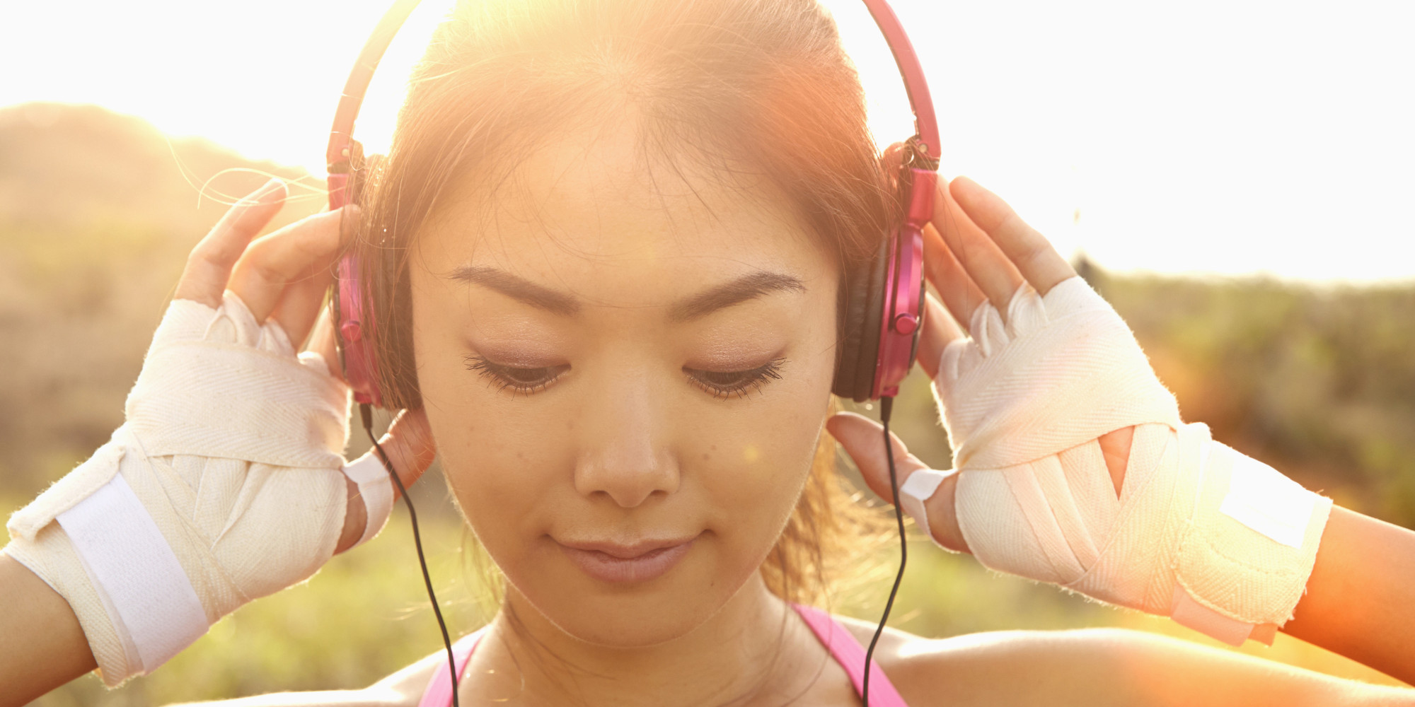 Japanese woman listening to headphones outdoors