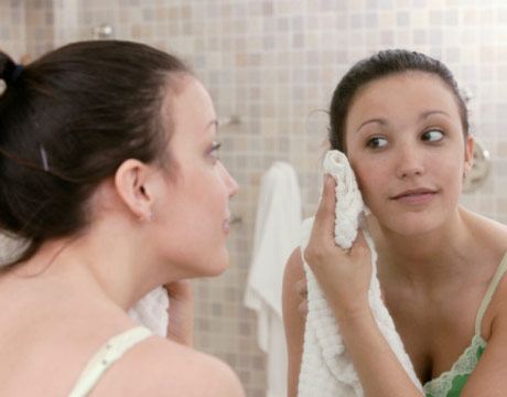 woman-washing-face-towel