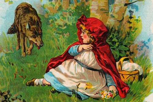 Color illustration from the fairy tale, Little Red Riding Hood depicting the character, Little Red Riding Hood, sitting on the grass and cowering as a wolf approaches her. | Part of: 'Grimm's Fairy Tales' by the Brothers Grimm. --- Image by © Bettmann/CORBIS